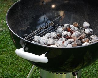 Hot coals sitting in a charcoal barbecue