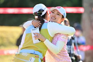 Ayaka Furue hugs Kokona Sakurai on the 18th green during the JLPGA Tour Championship