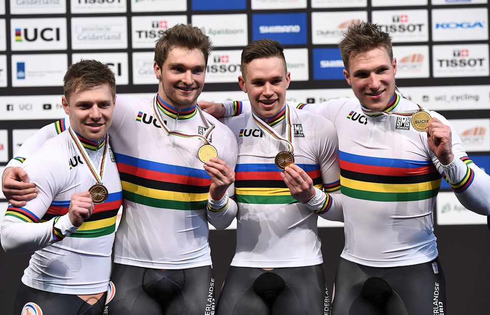 Netherlands gold medallists Nils van Thoenderdaal, Harrie Lavreysen, Matthijs Buchli and Jeffrey Hoogland pose on the podium after the men's team sprint final race