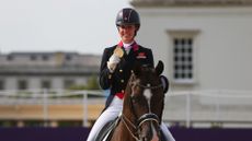 Charlotte Dujardin of Great Britain riding Valegro celebrates with her gold medal during the medal ceremony following the Individual Dressage of the London 2012 Olympic Games
