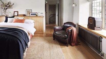 radiator in a bedroom with a leather armchair 