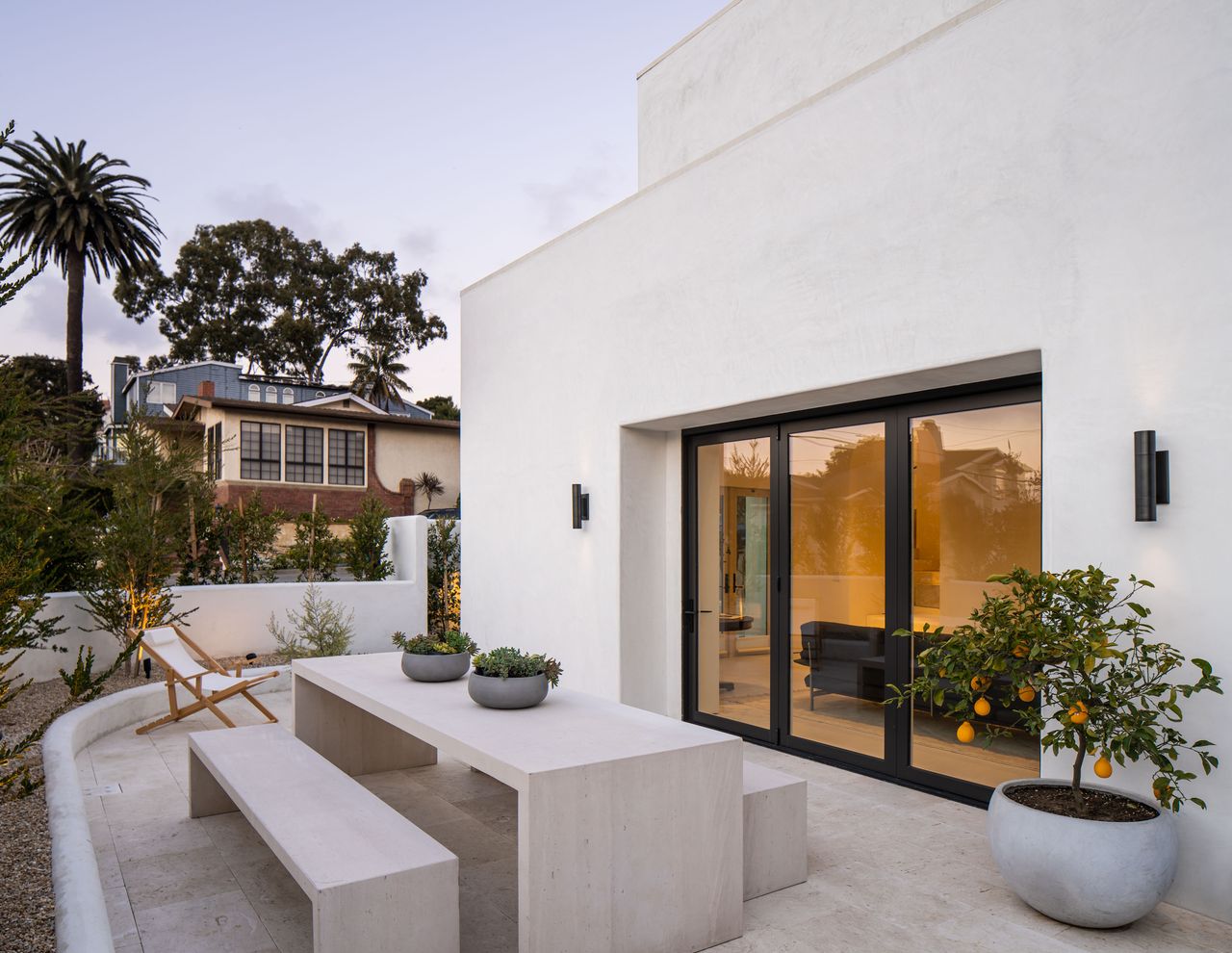 a small paved backyard with a fruit tree