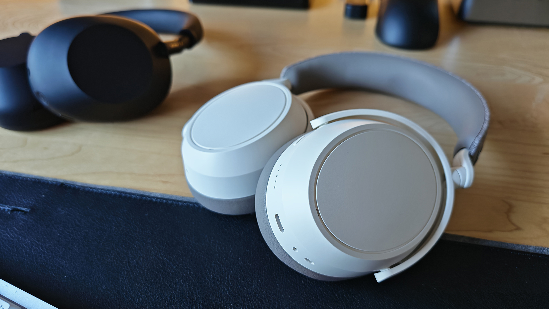 The Sony XM6s and the Momentum 4s on a desktop. 