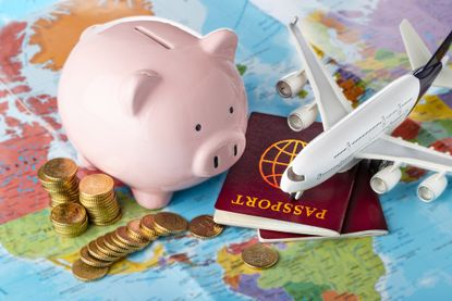 Travel money with piggybank, airplane and passport