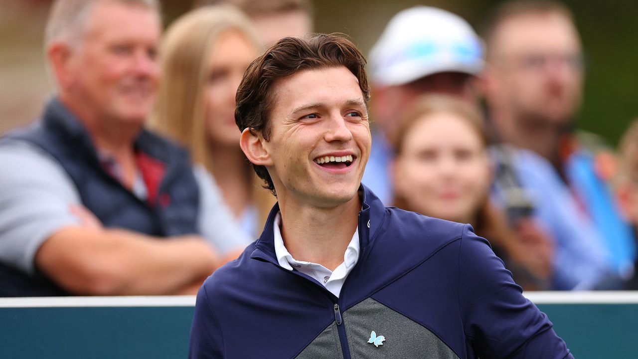 Tom Holland smiles on the first tee at the 2023 BMW PGA Championship Celebrity Pro-Am