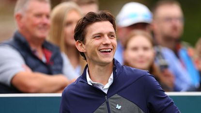 Tom Holland smiles on the first tee at the 2023 BMW PGA Championship Celebrity Pro-Am