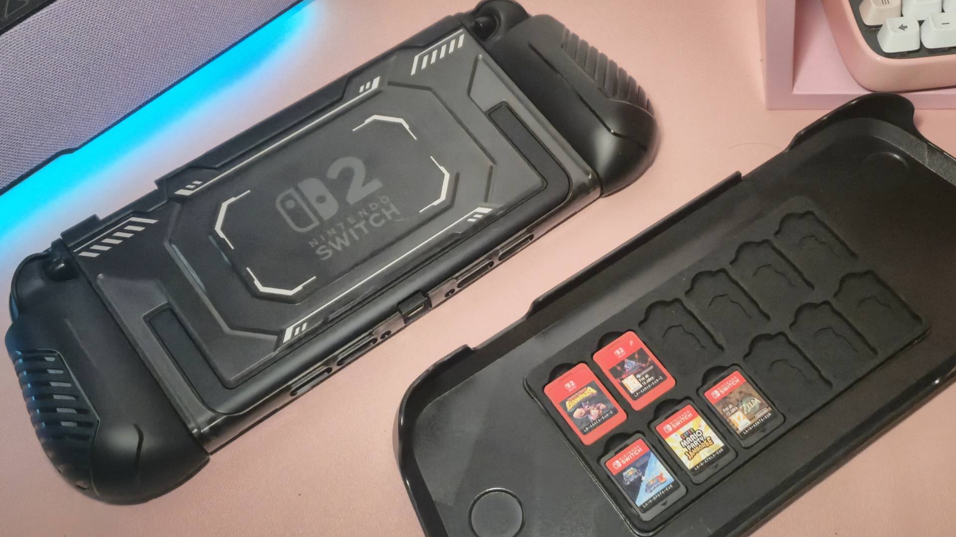 Photo of the back of the Fastsnail Switch 2 case and its top cover on a pink mouse mat.