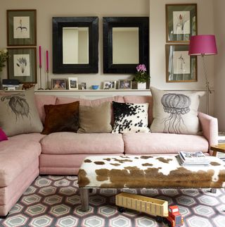 Grey living room with pale pink corner sofa and geo print carpet