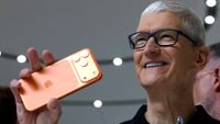 Tim Cook holding an iPhone