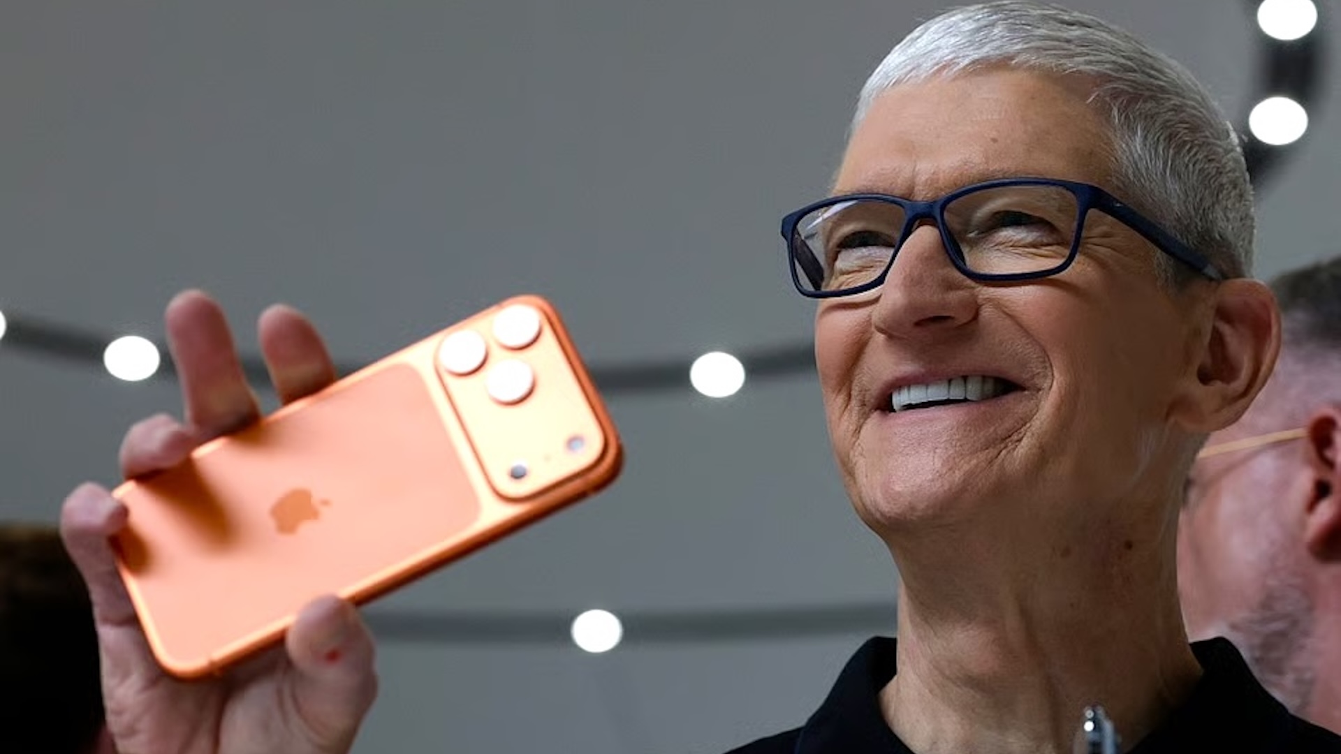Tim Cook holding an iPhone