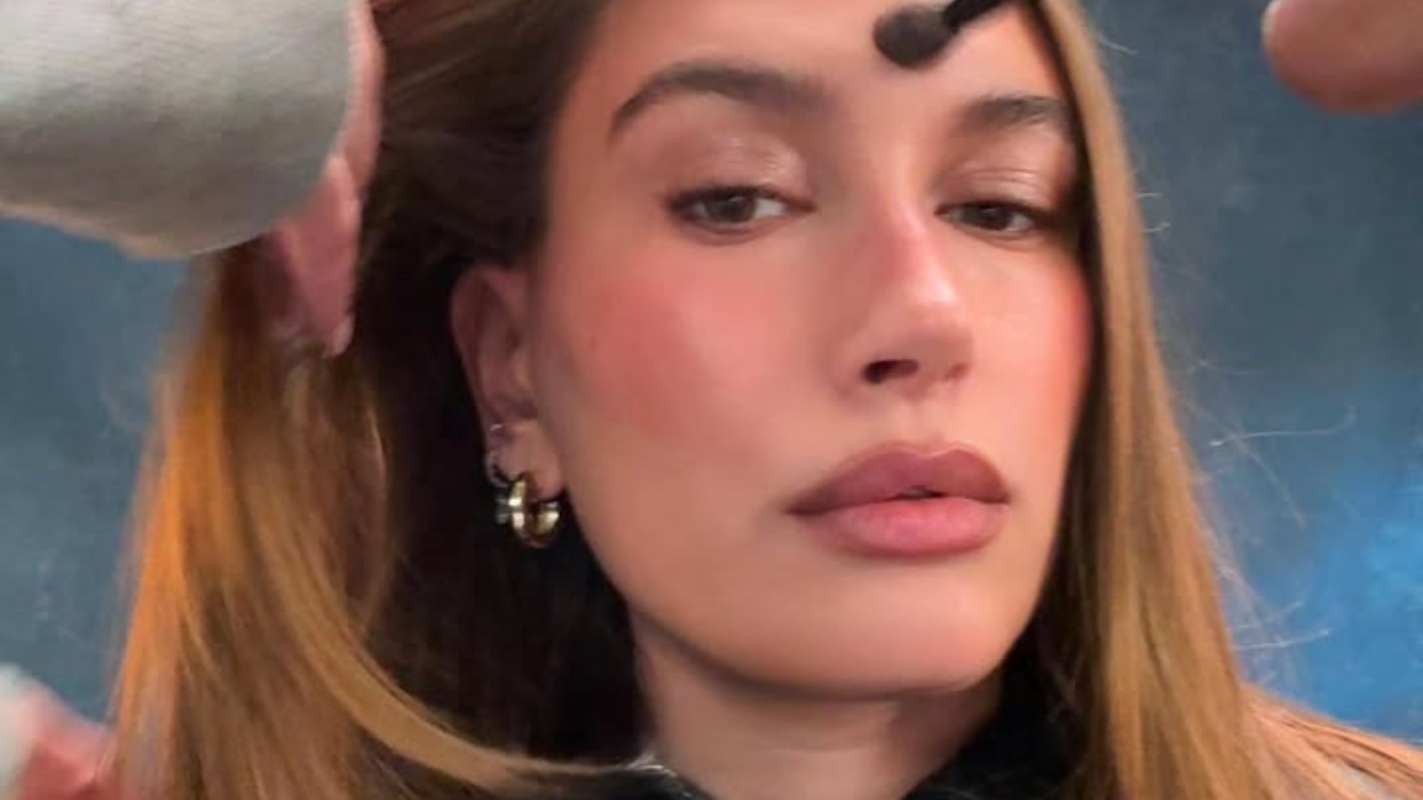 Selfie of Hailey Bieber as she gets her makeup and hair done.