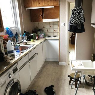kitchen area with wooden floor and counter with washing machine