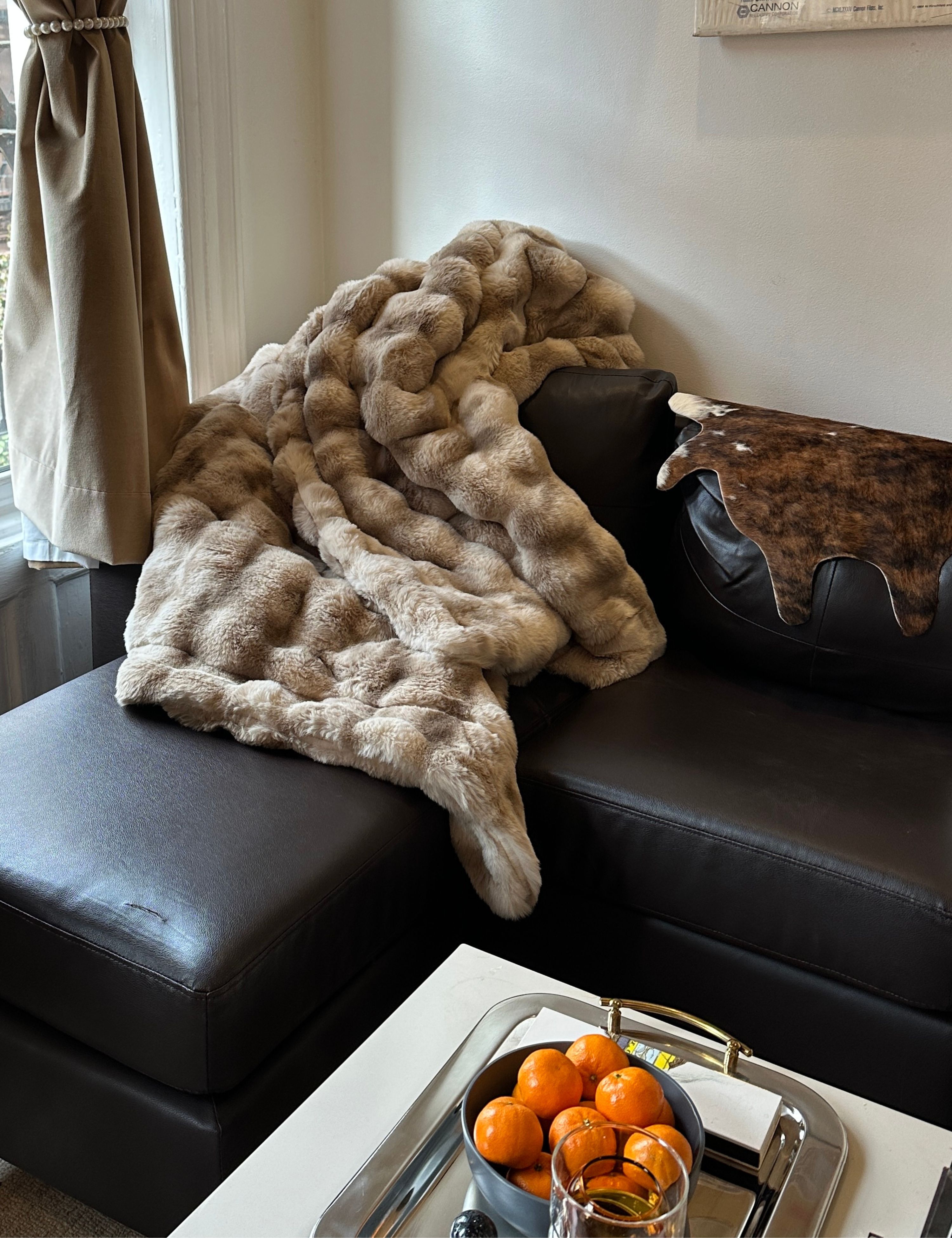 Lola Blanket draped over a mid-century style sofa
