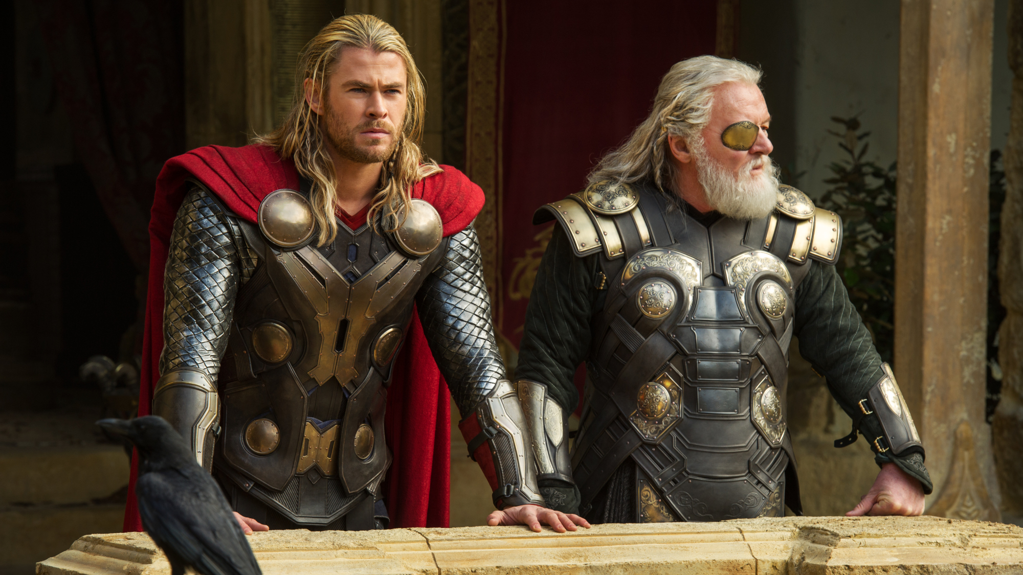 Thor (Chris Hemsworth) and Odin (Anthony Hopkins) stand together in Thor: The Dark World.
