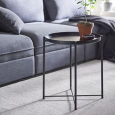 IKEA Gladom black side table in a living room with a grey sofa