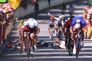 As Demare heads to the line, Degenkolb and Swift go down