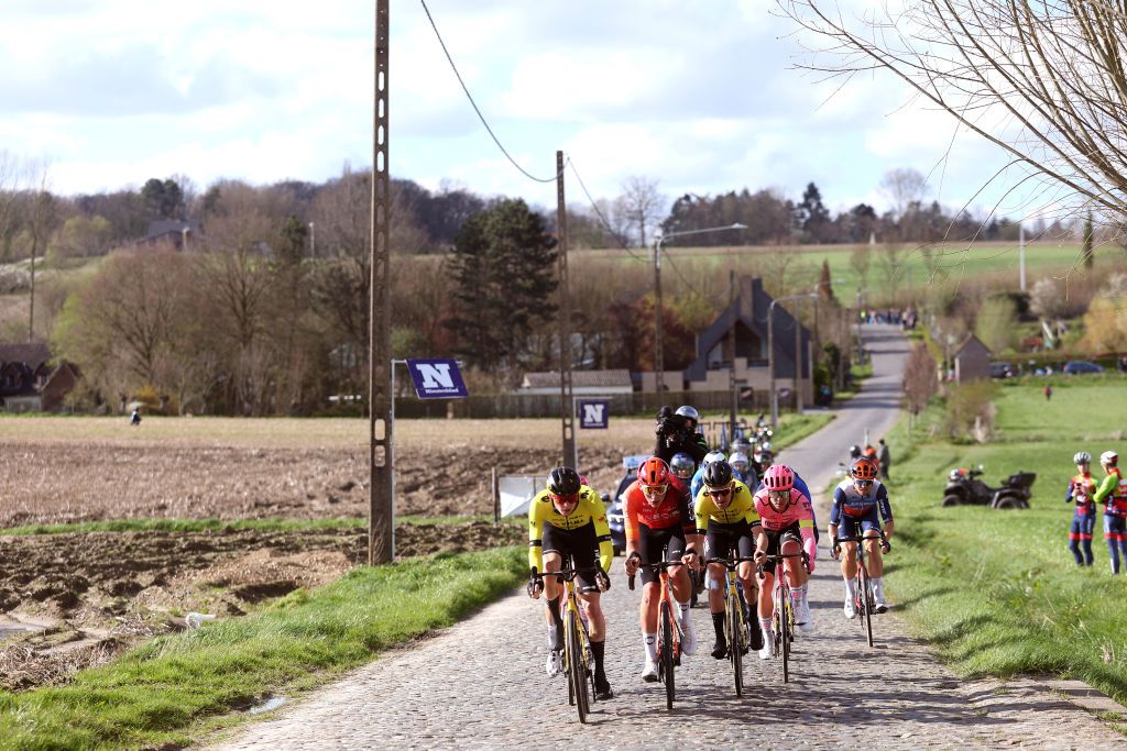 WAREGEM BELGIUM MARCH 27 LR Matteo Jorgenson of The United States and Team Visma Lease a Bike Joshua Tarling of The United Kingdom and Team INEOS Grenadiers Tiesj Benoot of Belgium and Team Visma Lease a Bike and Michael Valgren of Denmark and Team EF Education EasyPost compete in the chase group passing the Waregem cobblestones sector during the 78th Dwars Door Vlaanderen 2024 Mens Elite a 1886km one day race from Roeselare to Waregem UCIWT on March 27 2024 in Waregem Belgium Photo by Tomas Sisk PoolGetty Images