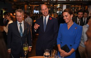 Catherine, Duchess of Cambridge (L) and Prince William, Duke of Cambridge (R) speak with guests at a reception for the key members of the Sustainable Markets Initiative