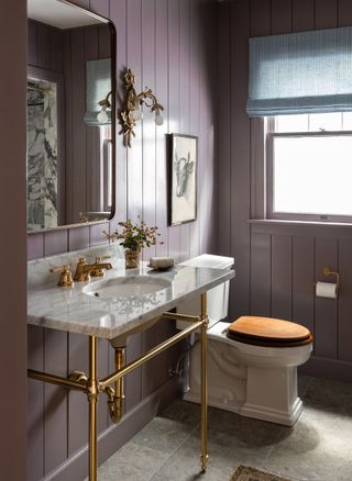 full length purple panels in bathroom with ceramic sink and WC
