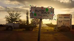 A sign that reads "alien rave this way" with an arrow pointing to the right