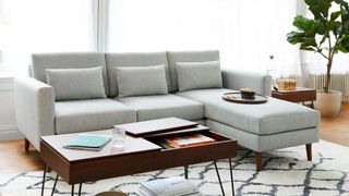 A light gray Burrow sectional in a living room for sustainable furniture brands.
