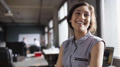 Woman smiling in an office.