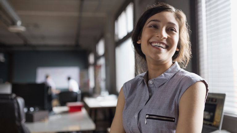 Woman smiling in an office.