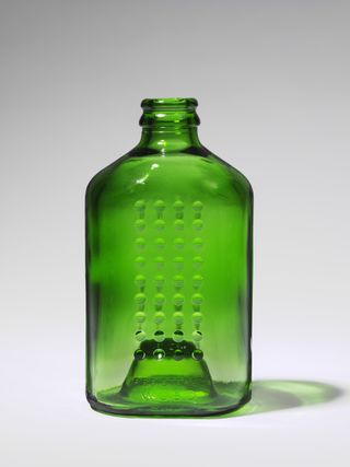 Green glass bottle in the shape of a brick