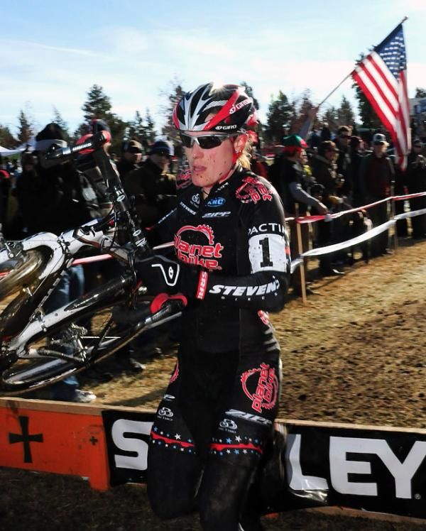 Katie Compton (Planet Bike) running the barriers.