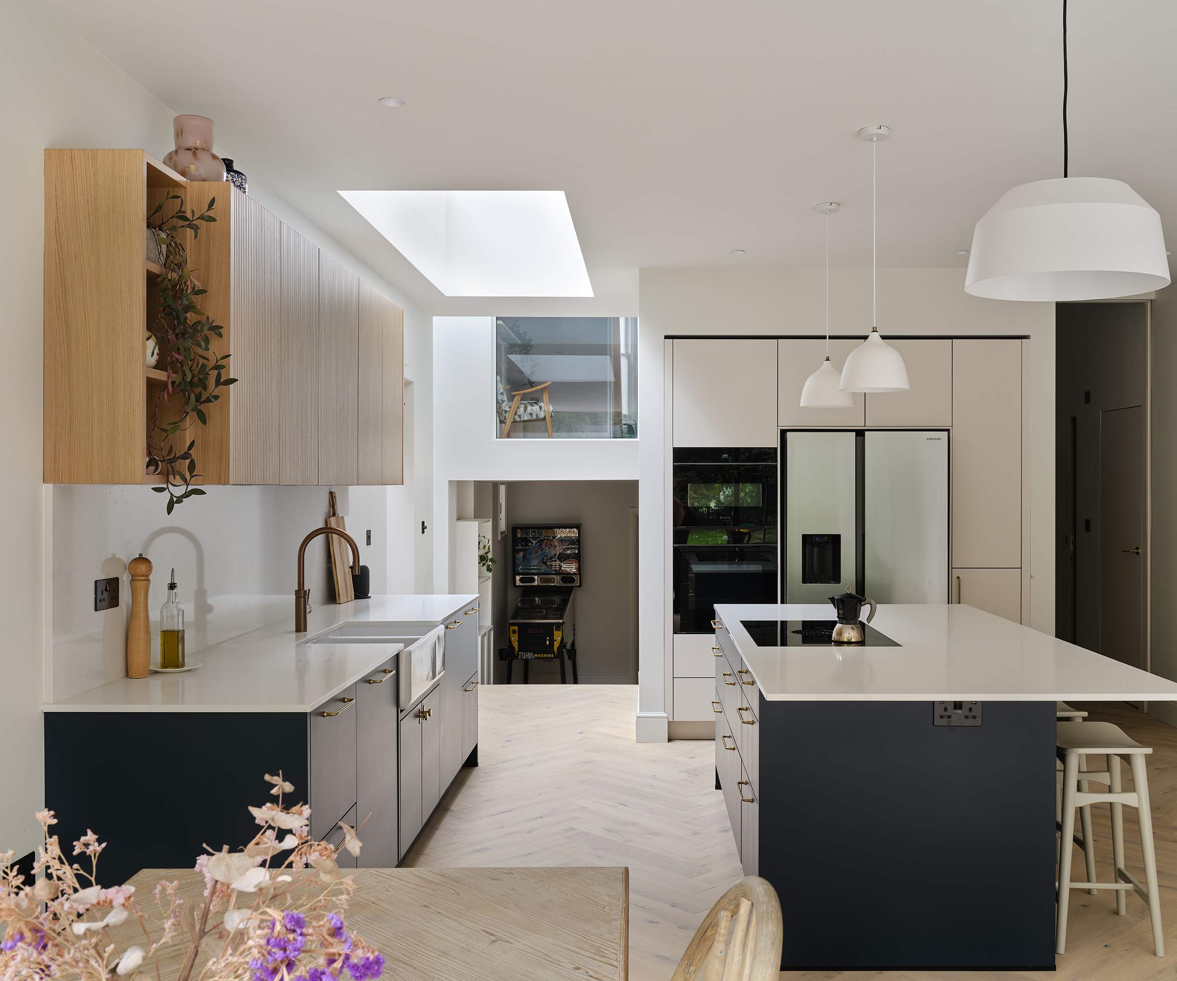 modern blue and white kitchen extension with roof lantern and double height spaces