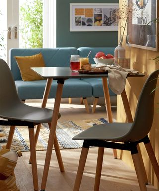 Small dining table near living room with two chairs