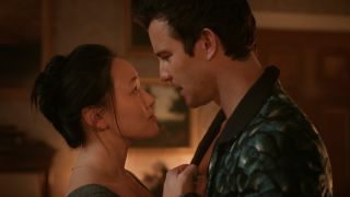 Sophie looking up at Benedict, they're holding each others' hands to their chests.