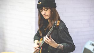 Sarah Longfield plays one of her signature Strandberg Boden Metal NX 8 guitars