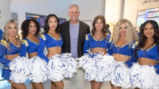 Mel Owens posing with cheerleaders for The Golden Bachelor Season 2