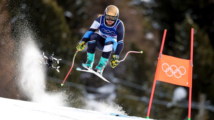 BORMIO, ITALY - FEBRUARY 07: Barnabas Szollos of Team Israel skis as a drone follows him down the course during the Men's Downhill on day one of the Milano Cortina 2026 Winter Olympics at Stelvio Alpine Skiing Centre on February 07, 2026 in Bormio, Italy. (Photo by Dustin Satloff/Getty Images)