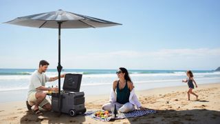 Family relaxing on the beach next underneath the Anker SOLIX Solar Umbrella