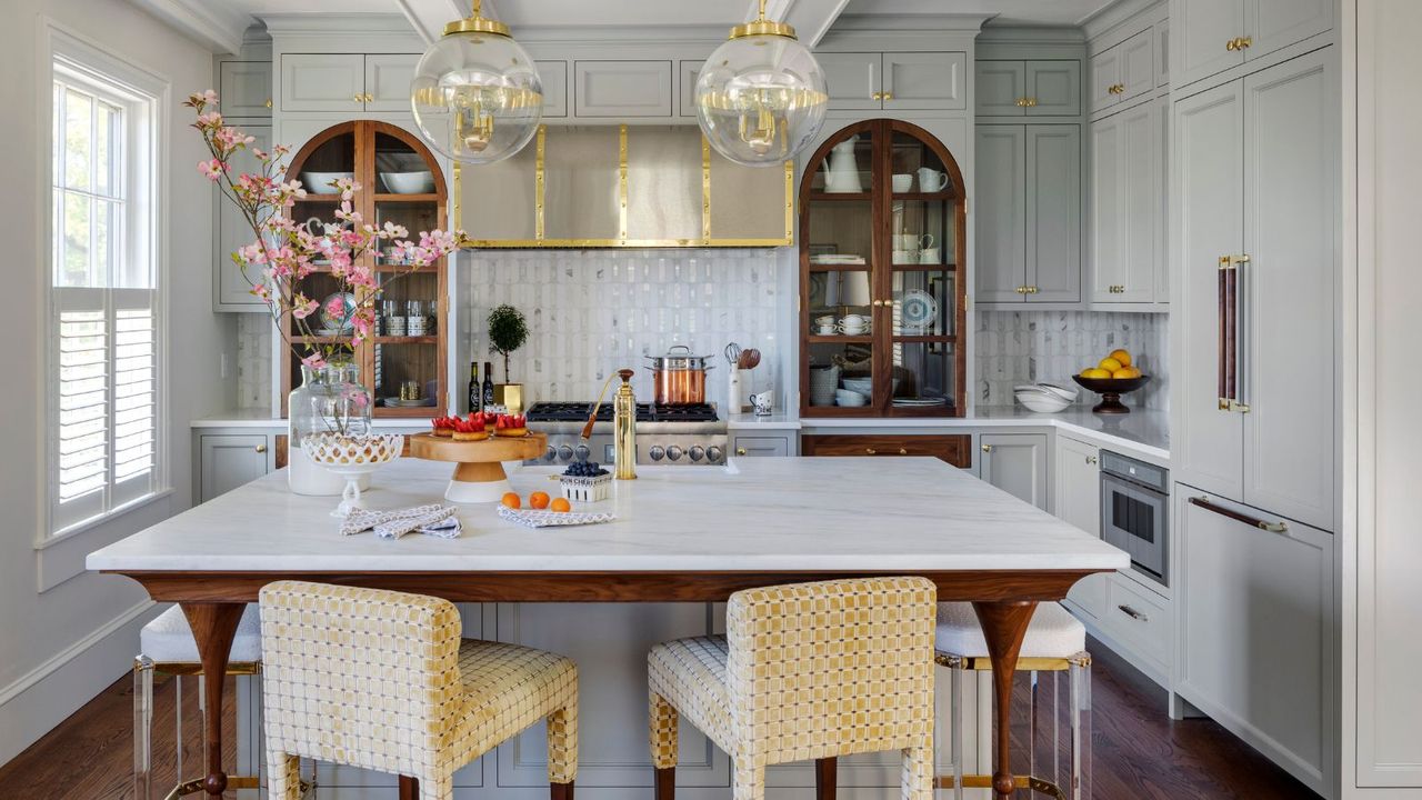 A blue and white kitchen with arched wooden cabinets