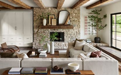 Living room with exposed brick wall, neutral furniture and accessories 