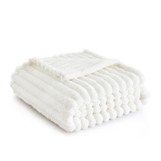 A white folded chunky throw blanket