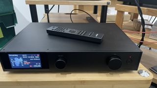 Audiolab 9000N with remote on wooden rack
