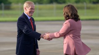 nasa administrator bill nelson in a suit shakes hands with vice president kamala harris in a pink blazer