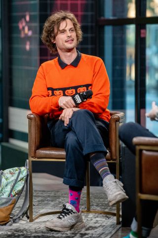 Matthew Gray Gubler wearing mismatched socks during an interview.
