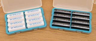 Eneloop rechargeable AA batteries in boxes on a table