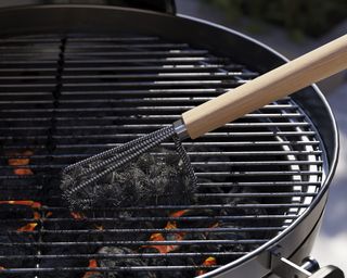 Grill cleaning brush on a bbq grill