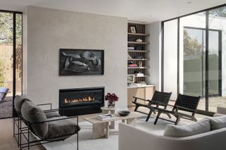 mid century living room with open fire and wood chairs