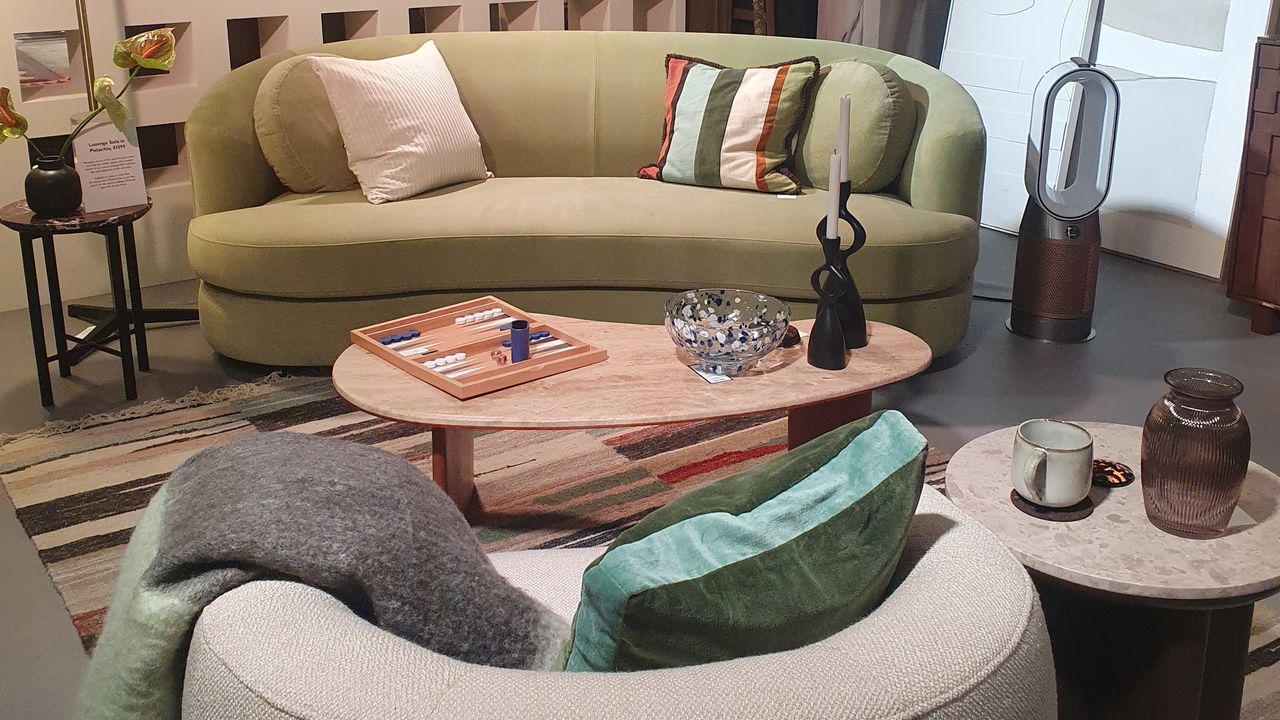 A living room set-up at the John Lewis spring/summer 2025 press showcase with a curved pistachio green sofa