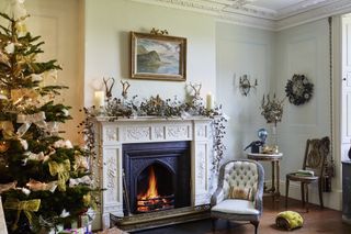 Christmas tree by fireplace in Cumbrian farmhouse