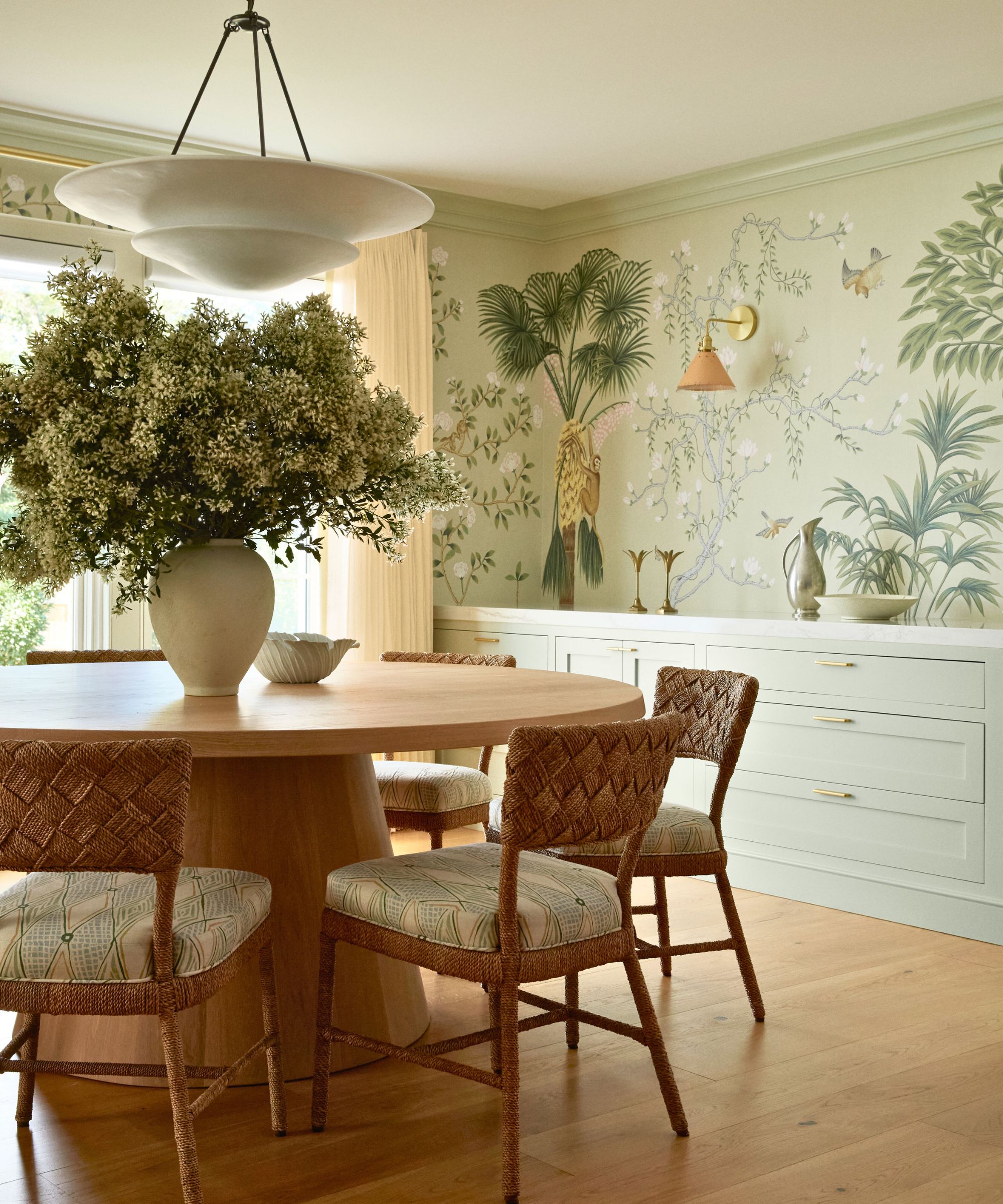 dining nook round table and mural wall with tropical print