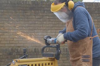 Cycling weekly writer Matt, attacking a litelok X3 with an angle grinder and of course wearing the appropriate PPE