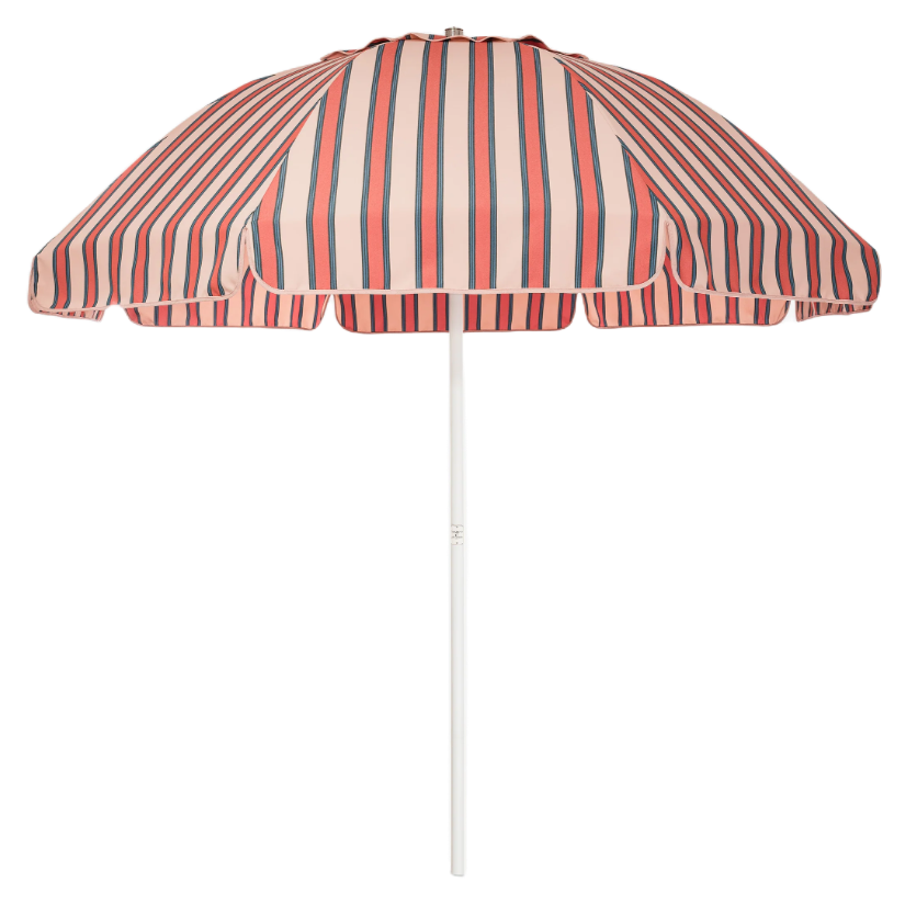 a pink and red stripe patio umbrella stock photo